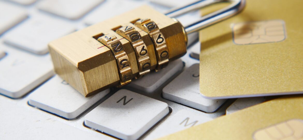a golden padlock sitting on top of a keyboard