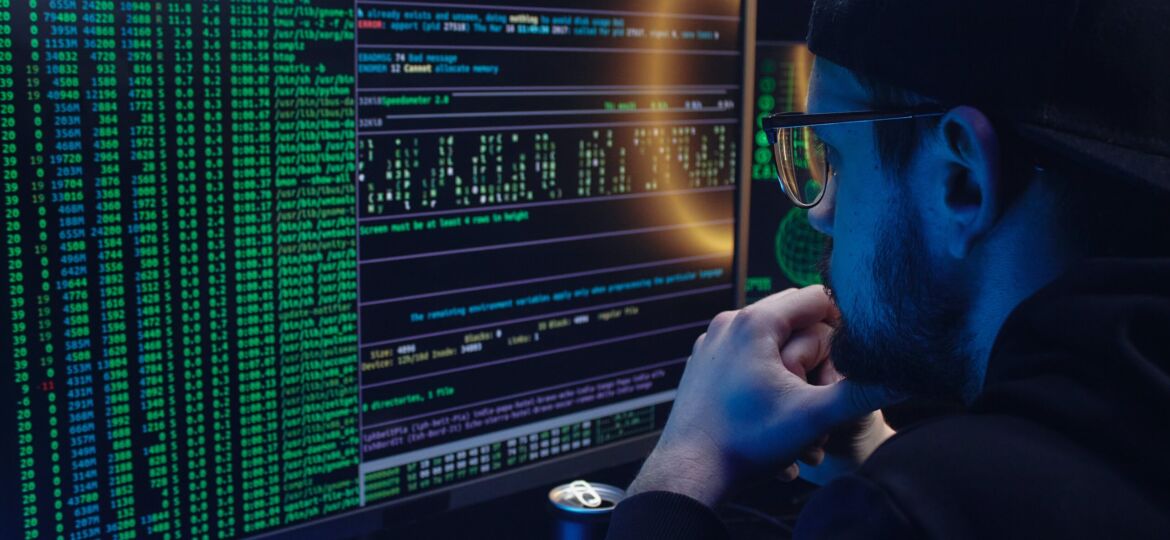 Free A Man Looking at a Computer Screen with Data Stock Photo