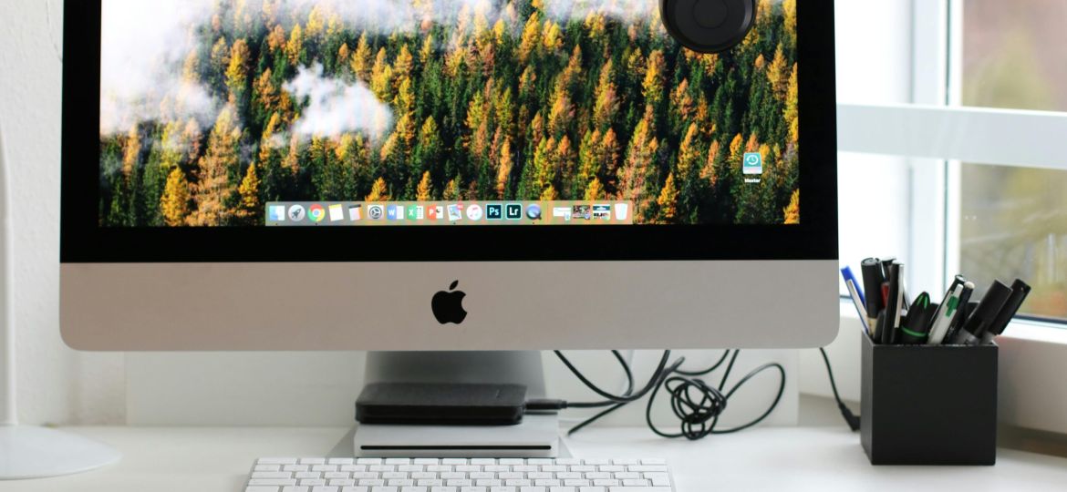 Free Stylish home office workspace featuring a computer setup with accessories. Stock Photo
