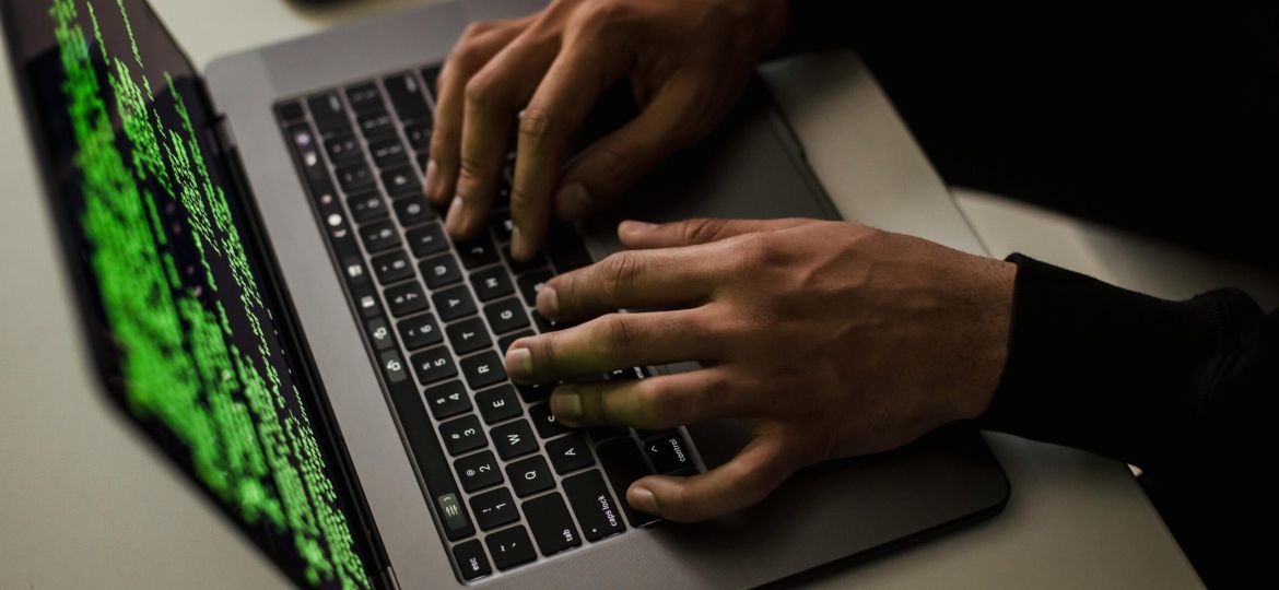 crop-cyber-spy-hacking-system-while-typing-on-laptop