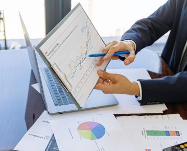 Free Business professionals discussing financial graphs and charts in an office setting. Stock Photo