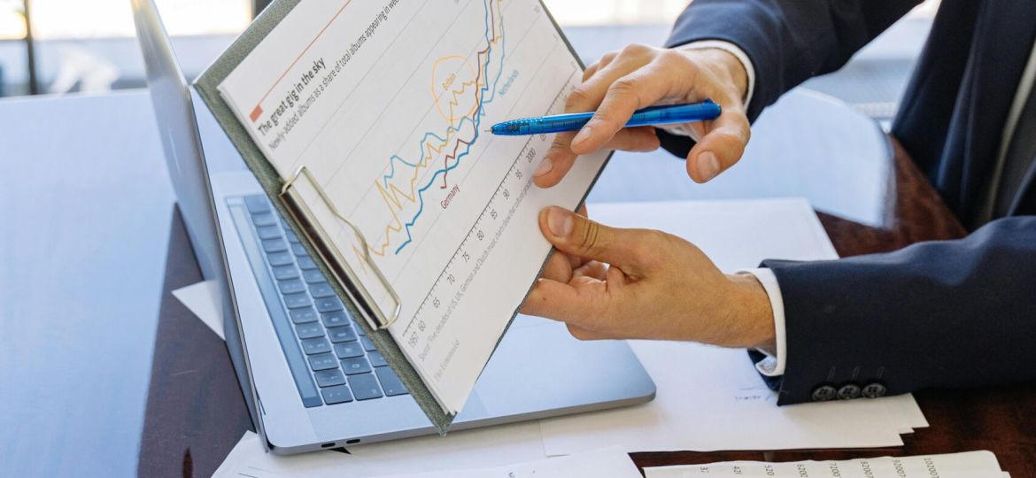 Free Business professionals discussing financial graphs and charts in an office setting. Stock Photo
