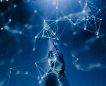 Free A robotic hand reaching into a digital network on a blue background, symbolizing AI technology. Stock Photo