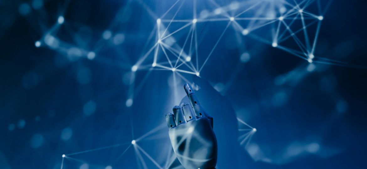 Free A robotic hand reaching into a digital network on a blue background, symbolizing AI technology. Stock Photo