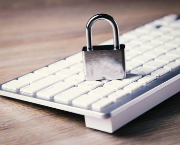 a computer keyboard with a padlock on top of it