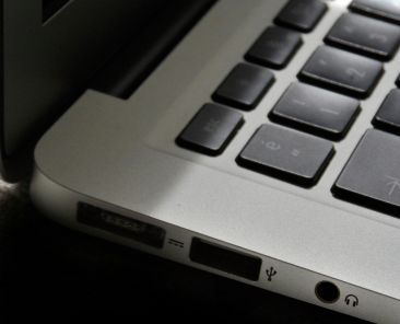 Free Detailed view of a silver laptop showing keyboard and multiple ports. Stock Photo