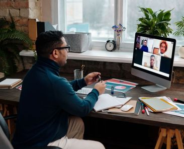 teacher-video-calling-with-his-students-using-a-computer